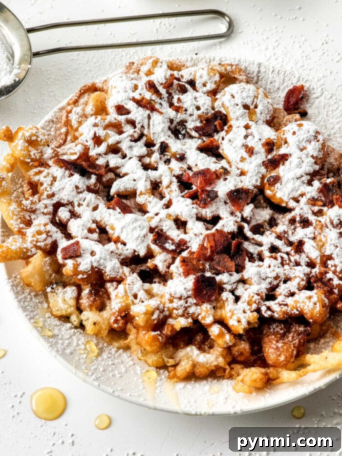 How to Make a Funnel Cake - A delicious homemade funnel cake, perfectly golden and dusted with powdered sugar, ready to be enjoyed.