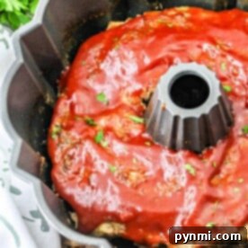 A delicious Bundt Pan Meatloaf with a glossy tomato sauce and fresh parsley garnish