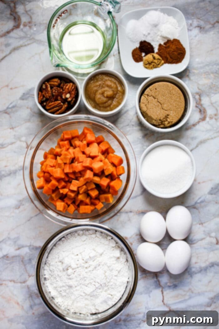 Baking ingredients on a marble surface for Sweet Potato Cake: eggs, flour, sugar, sweet potatoes, pecans, oil, applesauce, and spices.
