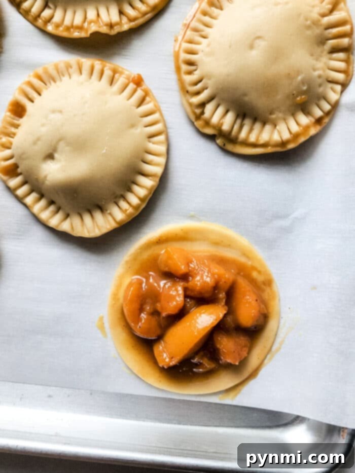 Sunshine Peach Pockets 4 A batch of golden-brown peach hand pies resting on a wire rack after being baked in an air fryer.
