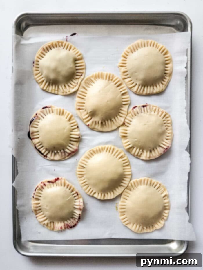 Blueberry Bliss Air Fryer Bites 5 Freshly baked hand pies with a sweet glaze, cooling on a rack.