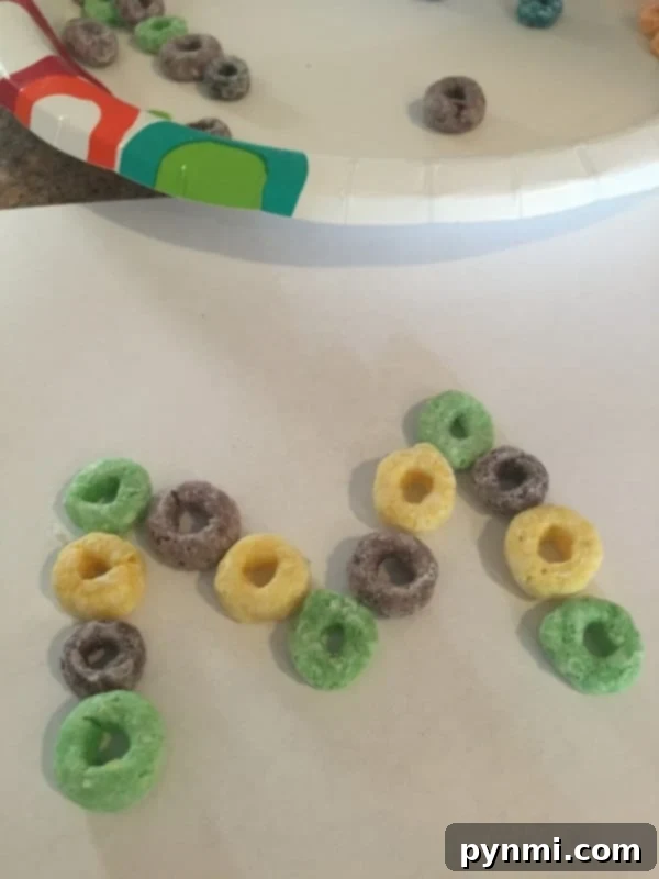 Sparkling Mardi Gras Crafts for Youngsters 4 cheap mardi gras craft - a child gluing cereal onto a paper
