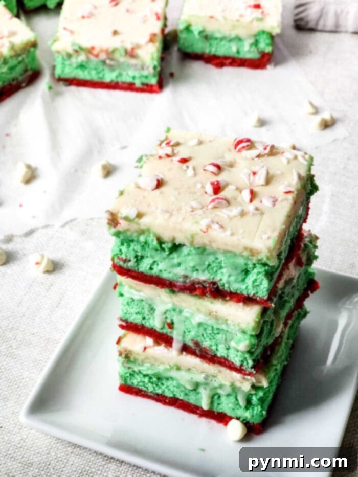 Decadent Sugar Cookie Lasagna 7 A festive Christmas dessert lasagna, showcasing distinct red and green layers, perfect for holiday gatherings.