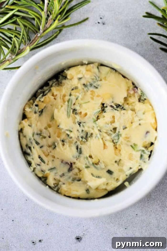 Mastering the Art of Cowboy Butter 2 Homemade Garlic Cowboy Butter in a ramekin, garnished with fresh herbs
