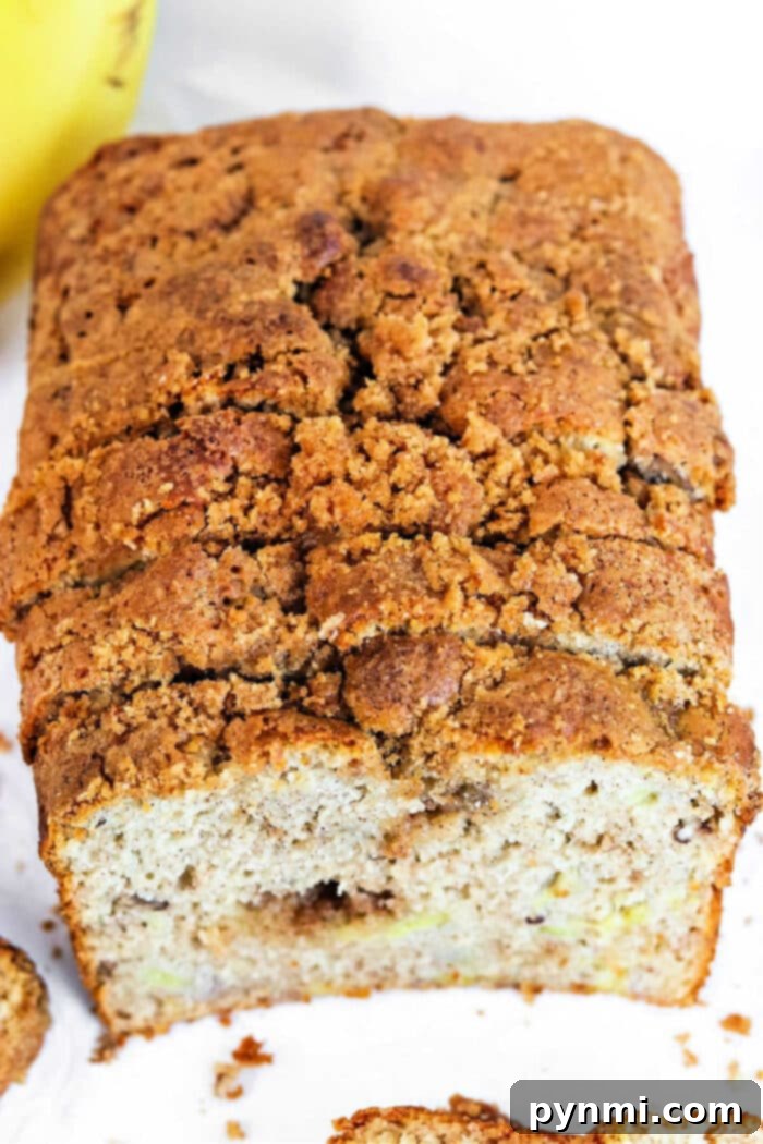 Irresistible Butter-Free Banana Bread 2 No Butter Banana Bread - A golden-brown loaf of banana bread sits on a wire rack, freshly baked and ready to be sliced, showcasing its perfect texture achieved without butter.