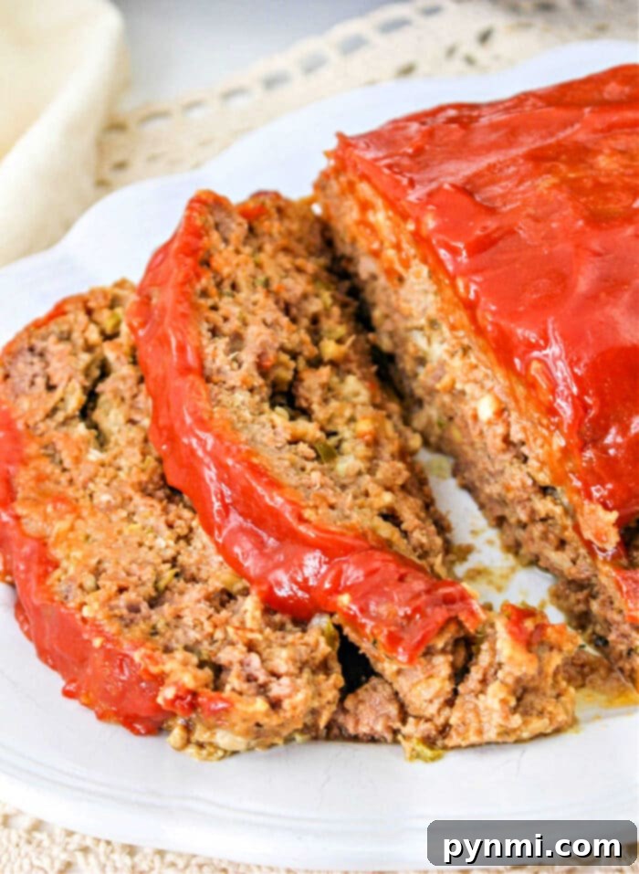 Slow Cooker Meatloaf Perfection 9 Final Crockpot Meatloaf Recipe, served on a plate with sides