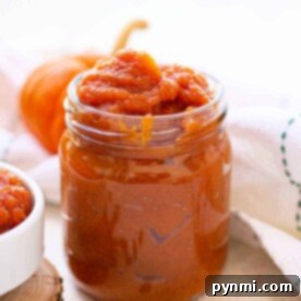 A jar of rich pumpkin jam, ready to be spread on toast.