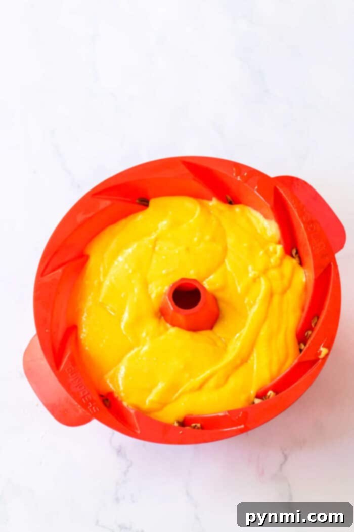 A delectable pecan rum cake, rich in color and texture, stands ready to be sliced and enjoyed.
