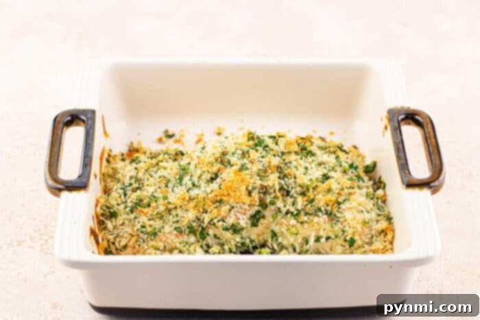 A delectable platter of herb-crusted salmon with mayonnaise, beautifully presented with fresh lemon and parsley.