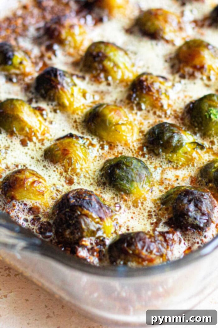Parmesan Crusted Brussel Sprouts with crispy bacon bits sprinkled over them.