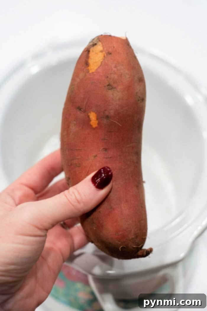 Set It and Forget It Whole Sweet Potatoes 3 Sweet Potatoes cooking in a Crock Pot