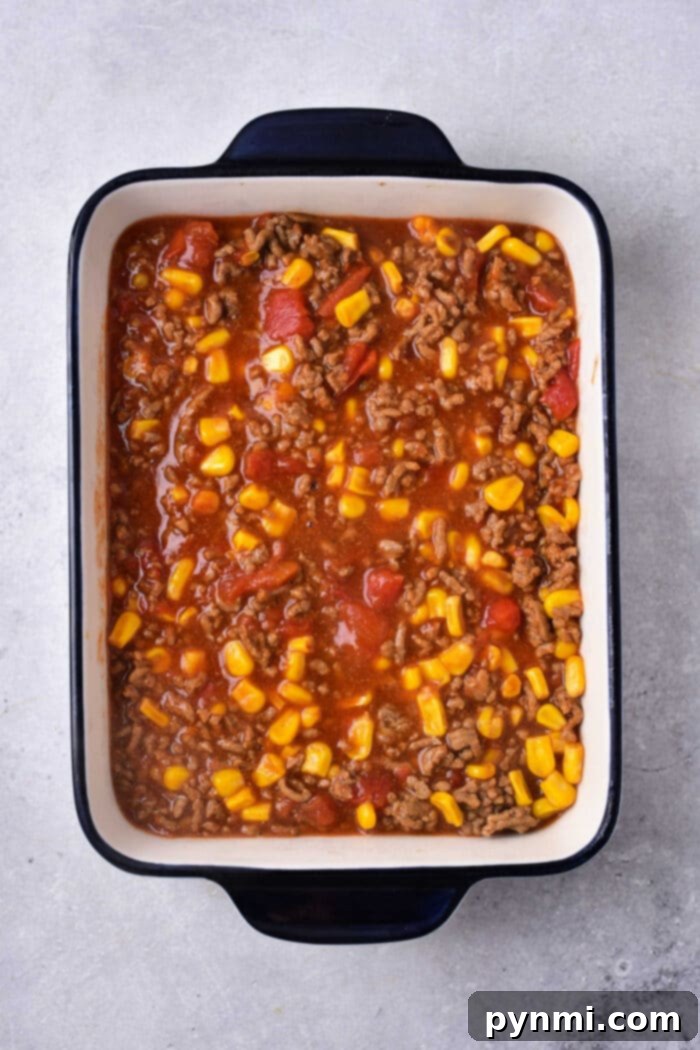Hearty Mexican Cornbread Bake 3 A vibrant cornbread Mexican casserole in a baking dish, ready to be served.