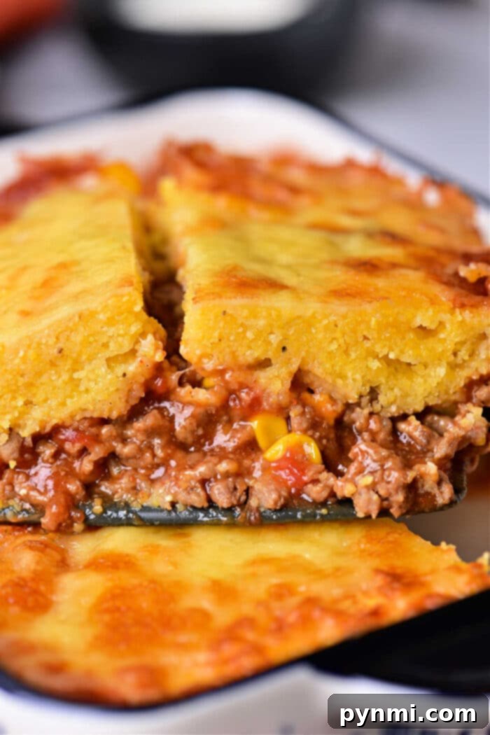 Hearty Mexican Cornbread Bake 7 A large serving of Mexican Cornbread Casserole, garnished and ready to eat.