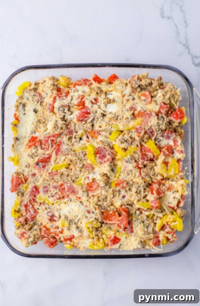 Rotel Dip in a white dish with a variety of dippers including bread slices and tortilla chips, perfect for sharing.