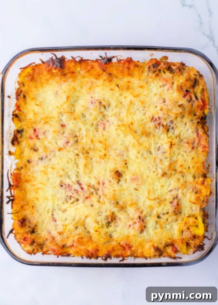 Sausage Rotel Dip served with various crackers and bread for dipping, presented on a wooden board.