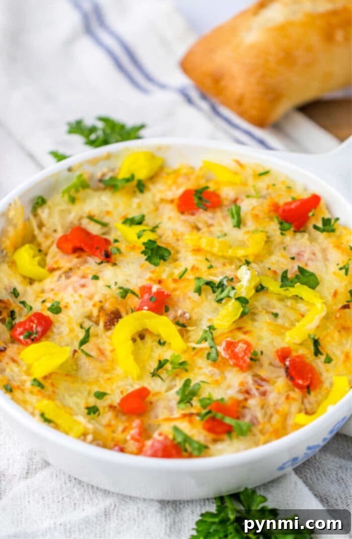 Sausage Cream Cheese Dip in a rustic ceramic dish, garnished with fresh cilantro, ready to be enjoyed.