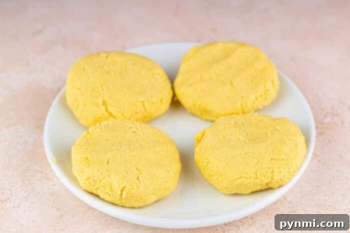 Kettle Cornbread Comfort 3 Cooking hot water cornbread in a cast iron pan, showing the golden-brown crust forming.