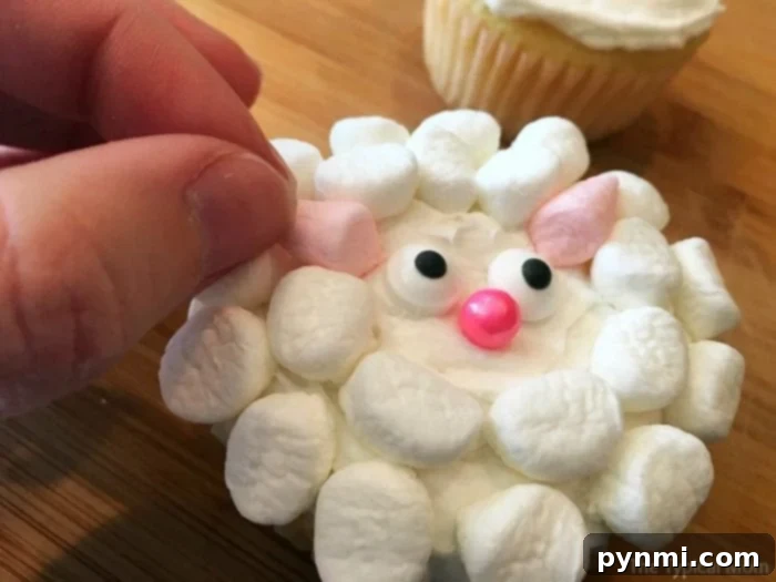 Girl's Birthday Parties That Won't Break the Bank 3 Adorable sheep cupcakes with fluffy white frosting and candy eyes, a creative cupcake idea.