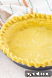 Buttery Shortbread Pie Crust 10 Unbaked shortbread pie crust in a pan with fluted edges, resting on a light surface