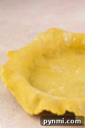 Buttery Shortbread Pie Crust 9 A shortbread pie crust rests in a fluted-edge pie pan