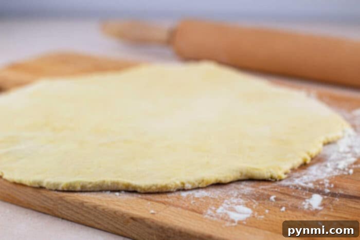 Dairy-Free Pie Crust Made Simple 5 Dairy Free Pie Dough resting on a floured surface, ready to be rolled out.