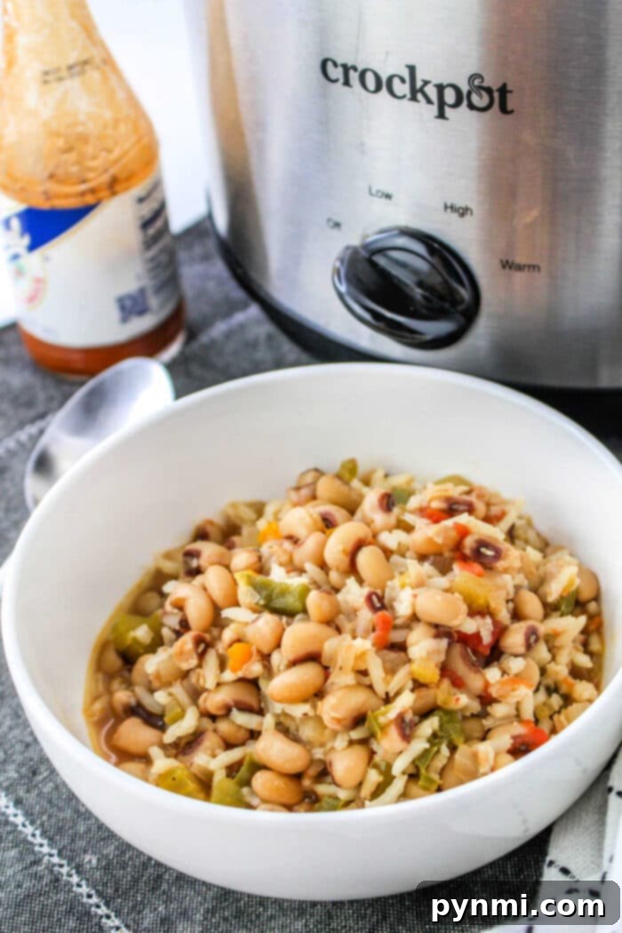 Black Eyed Peas with Rice, served in a bowl with a spoon.