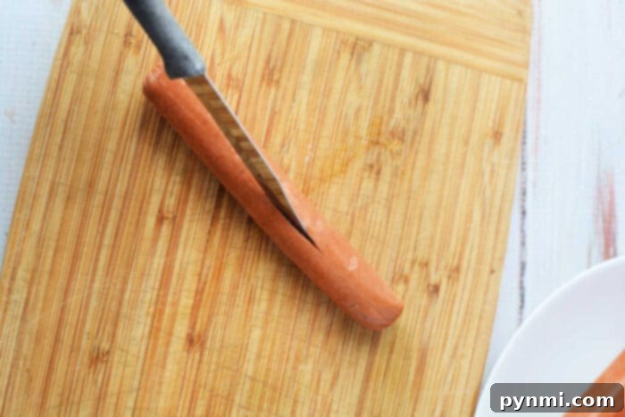 how to bake hot dogs on a baking sheet, showing the score marks for perfect expansion.