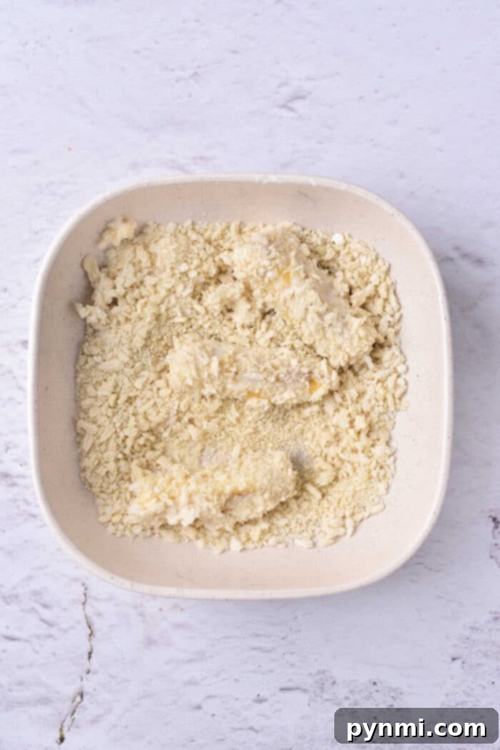Golden Banana Tempura Perfection 5 A tantalizing view of dessert tempura, featuring crispy banana slices generously dusted with powdered sugar, ready to be enjoyed.