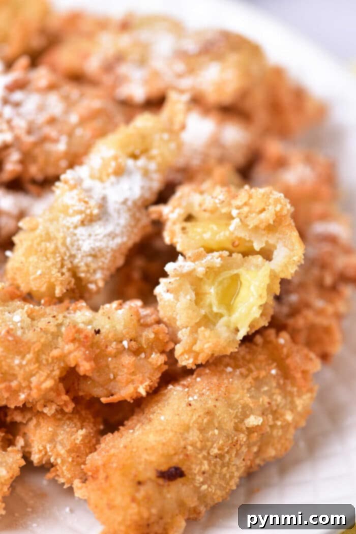 Golden Banana Tempura Perfection 6 A vibrant close-up of golden-fried bananas, glistening and inviting, ready to be presented as a delicious dessert.