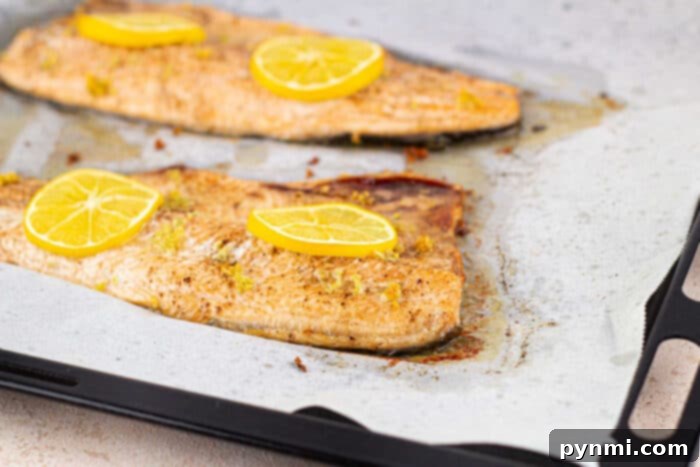 Close-up of golden-brown oven-baked trout with lemon