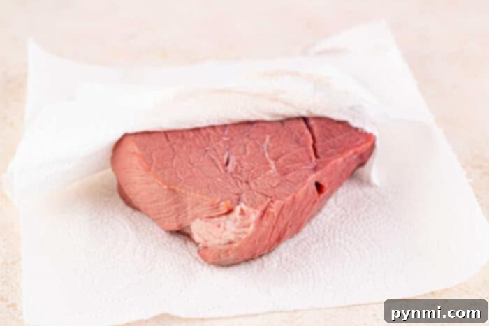 Roast Beef with Bottom Round, served with a rich red wine sauce and mashed potatoes.