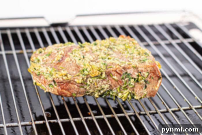Close-up of a tender, easy roast beef recipe slice with a pink center.