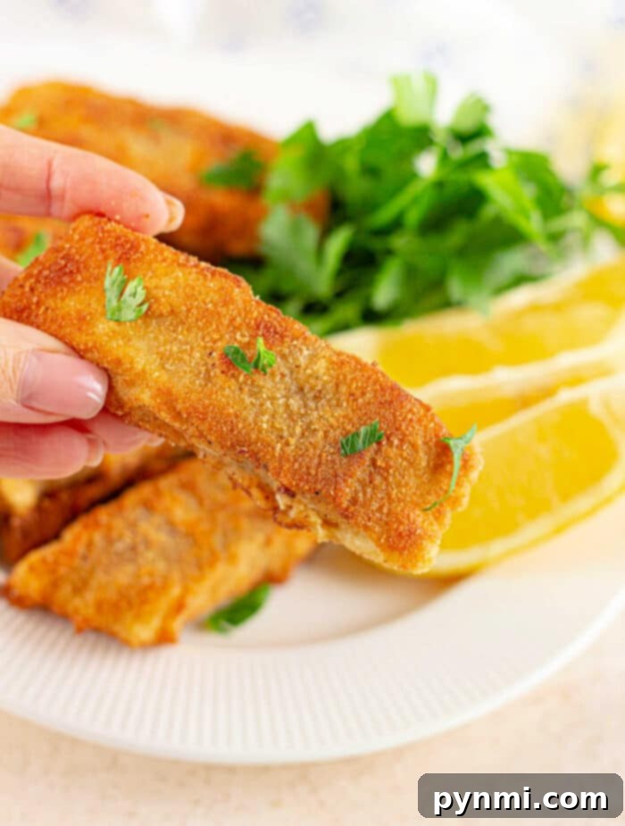 Copycat Zatararain's Fish Fry Recipe - Plated crispy fish with lemon