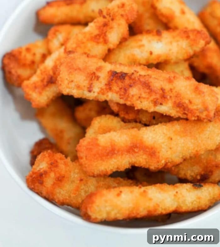 Get That Crunch Back Air Fry Your Leftover Fried Fish 4 A bowl of crispy, golden-brown breaded fried fish stacked together, as irresistibly delightful as reheating fried fish in an air fryer.