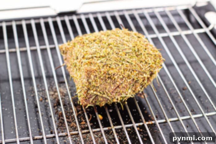 Close-up view of a bottom round roast cooking in the oven, with an internal temperature probe ensuring accuracy.