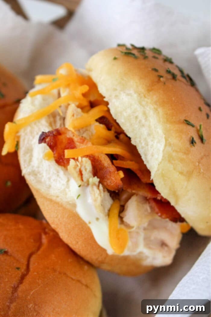 Chicken Bacon Ranch Sliders - A full platter of perfectly baked and golden-brown chicken bacon ranch sliders, ready for immediate serving at a gathering.