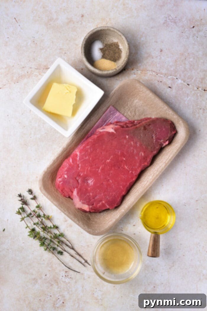 Mastering Chuck Steak 3 Marinated chuck steak on a cutting board with herbs, ready for cooking.