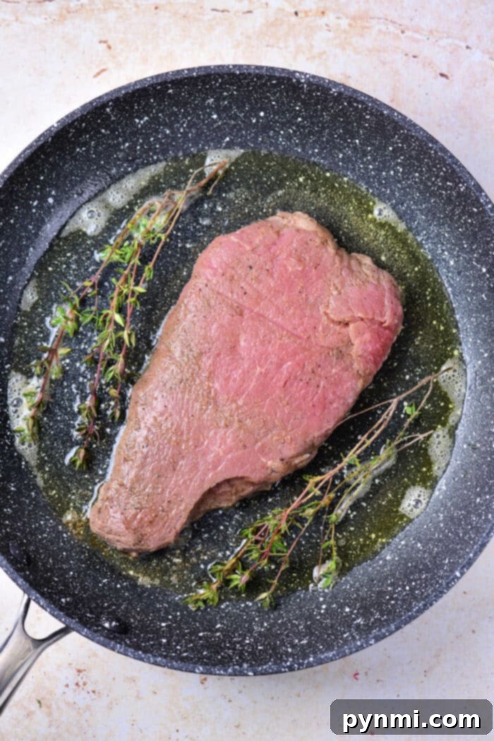 Mastering Chuck Steak 6 Chuck steak resting on a cutting board after cooking, before slicing.