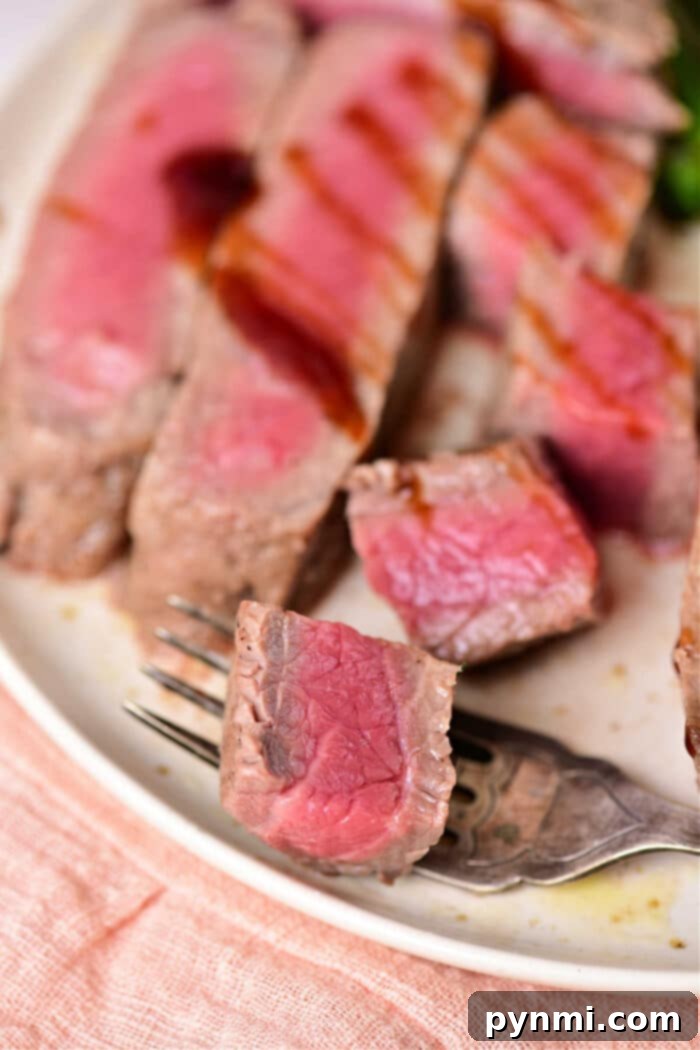 Mastering Chuck Steak 7 Two plates of chuck steak with side dishes, perfectly cooked.