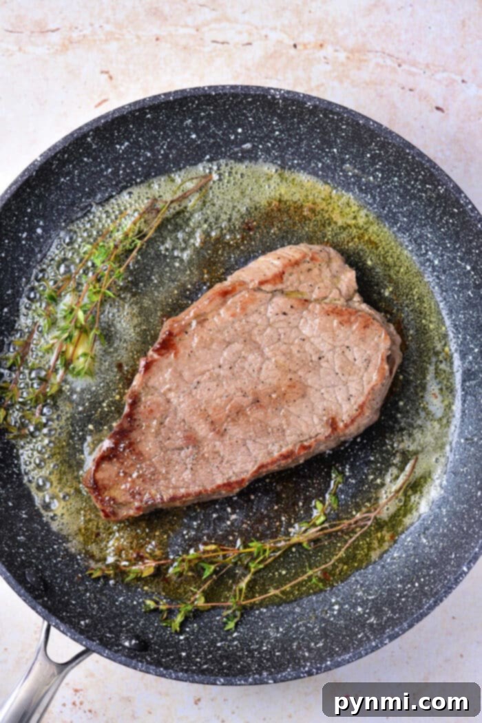 Mastering Chuck Steak 9 Cooked chuck steak served with creamy mashed potatoes and green beans.