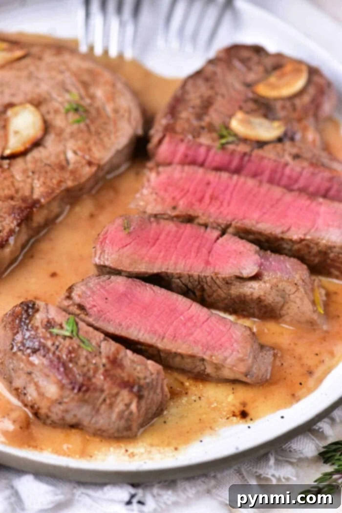 Sliced medium-rare with garlic and herbs beef tenderloin medallions.