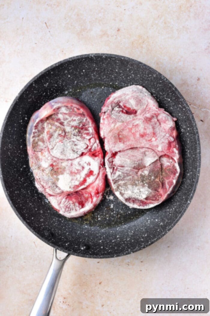 Osso Buco on Stove top with rich tomato sauce and herbs.