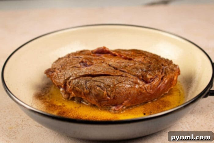 Seared chuck roll steak in a pan