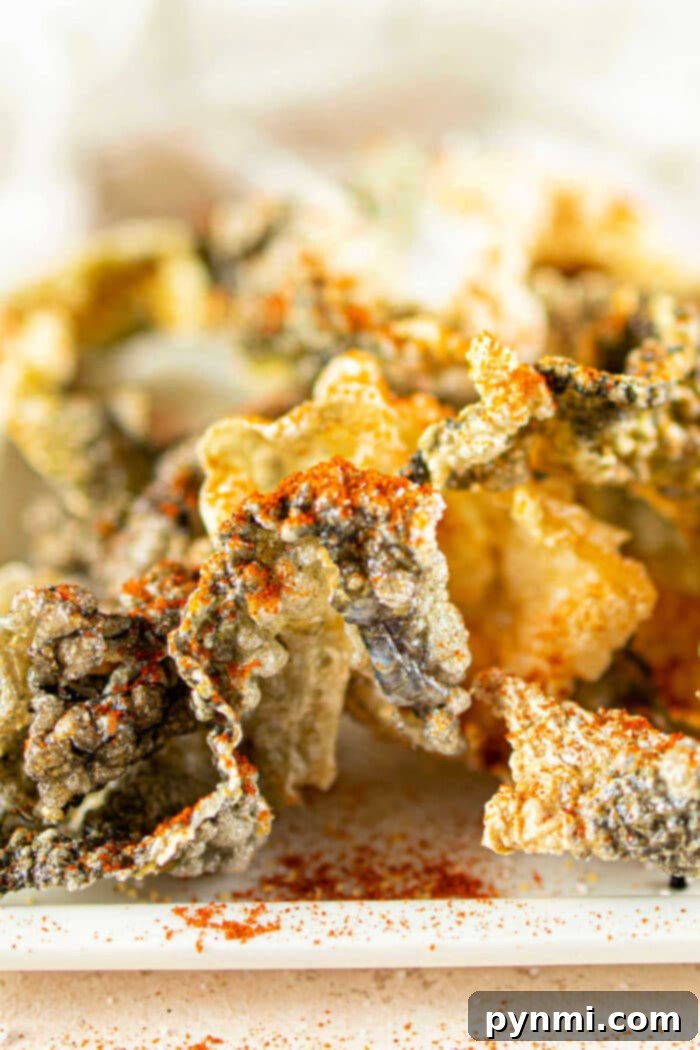 Golden Fish Skin Cracklings 7 A vibrant bowl of crispy Fish Skin Chips, freshly seasoned and ready to be served, emphasizing their appeal as a delicious snack.