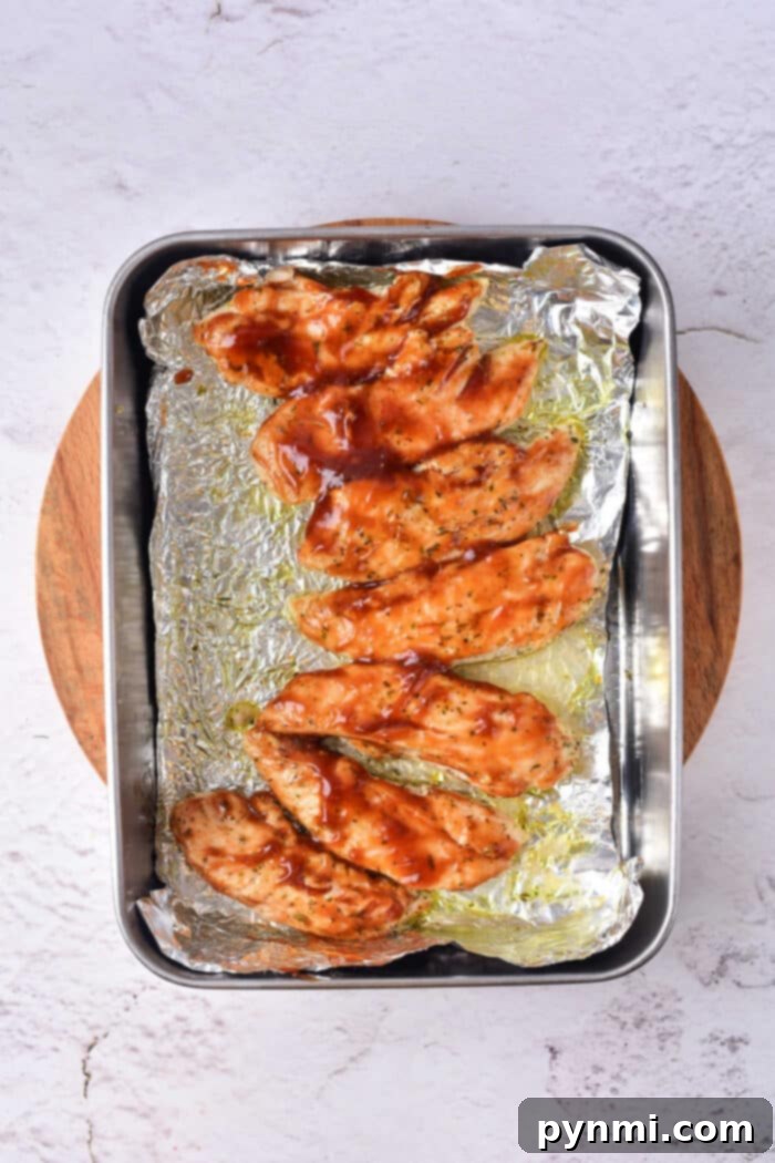 Naked Oven Baked Chicken Tenders 6 Reheated oven baked chicken tenders on a plate, ready to be served.