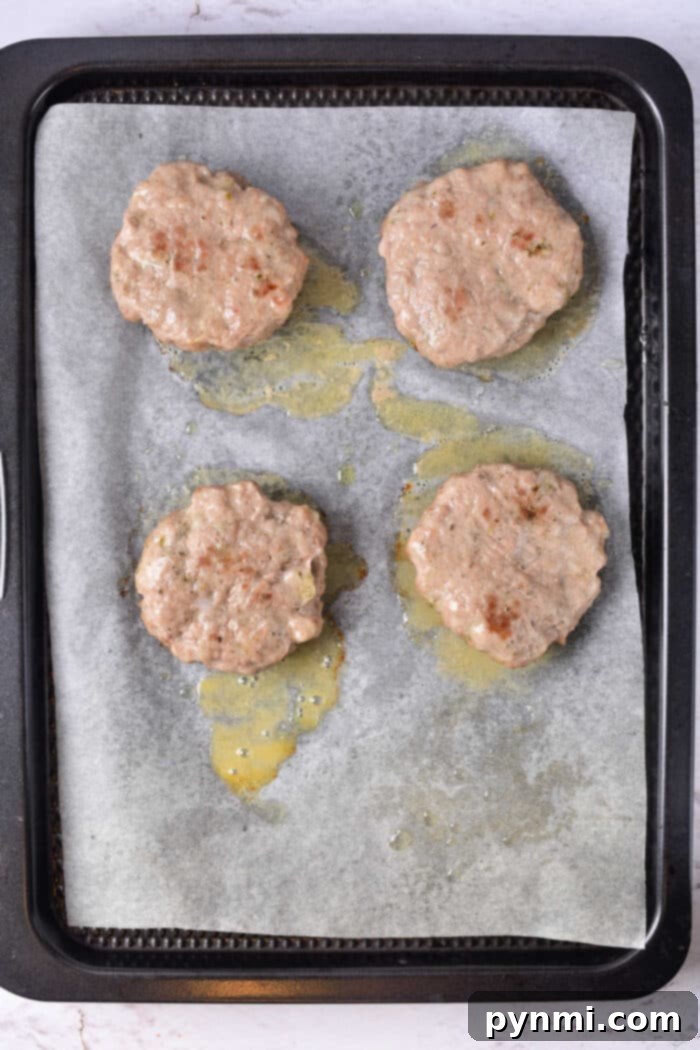 Cooking Sausage Patties in Oven: A baking sheet filled with freshly baked, golden-brown sausage patties, ready to be enjoyed.