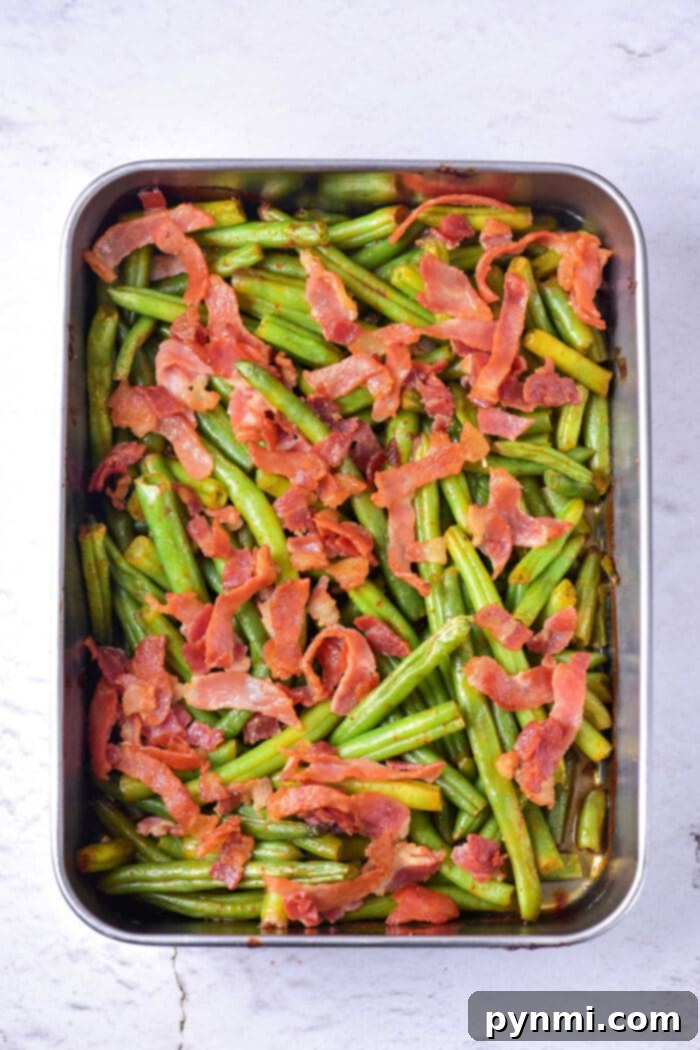 Green Bean Obsession 6 A serving of Crack Green Beans with Bacon and a rich sauce, plated elegantly for a delicious meal.