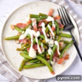 Green Bean Obsession 7 A plate of crack green beans with crispy bacon and creamy sauce, ready to be enjoyed.