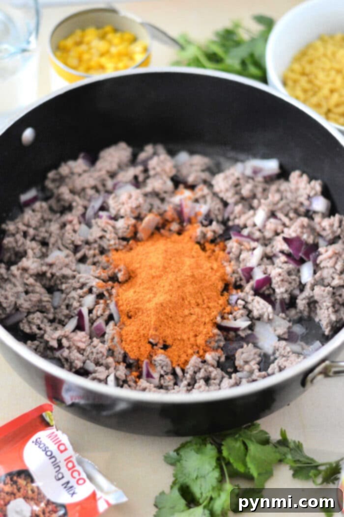 Crunchy Taco Beef Skillet 4 Close-up of homemade Taco Hamburger Helper in a skillet with ground beef and pasta.