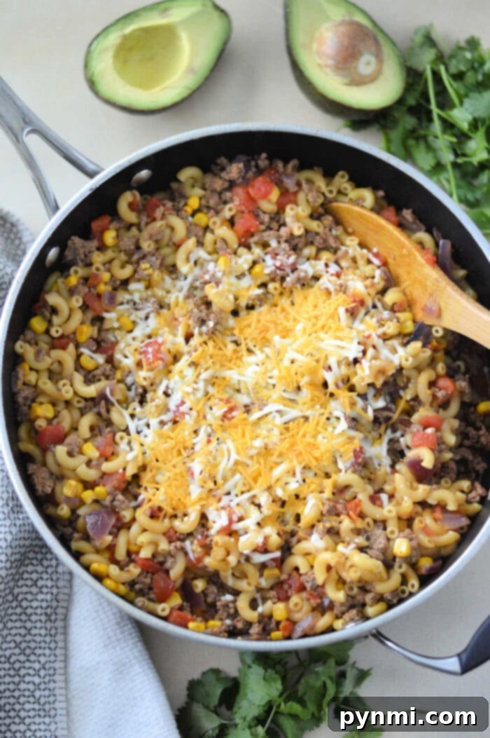 Crunchy Taco Beef Skillet 6 Hamburger Helper with Taco Seasoning served in bowls with toppings.
